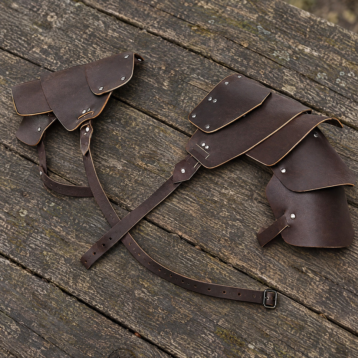 Brown layered double pauldrons on a rustic surface