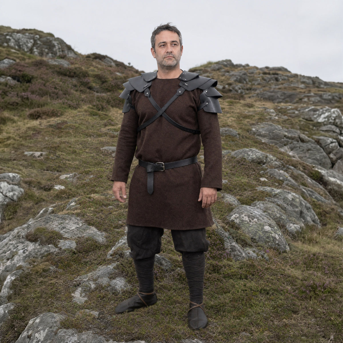 Black layered double pauldrons worn outdoors, full-length front view