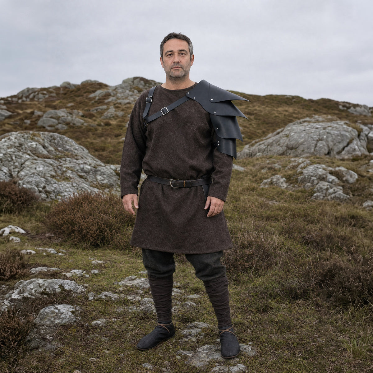 Black layered shoulder armour worn outdoors, full-length front view