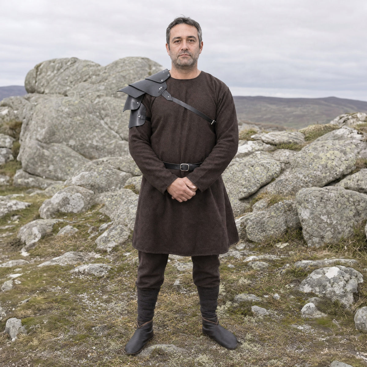 Black layered single pauldron worn outdoors, full-length front view