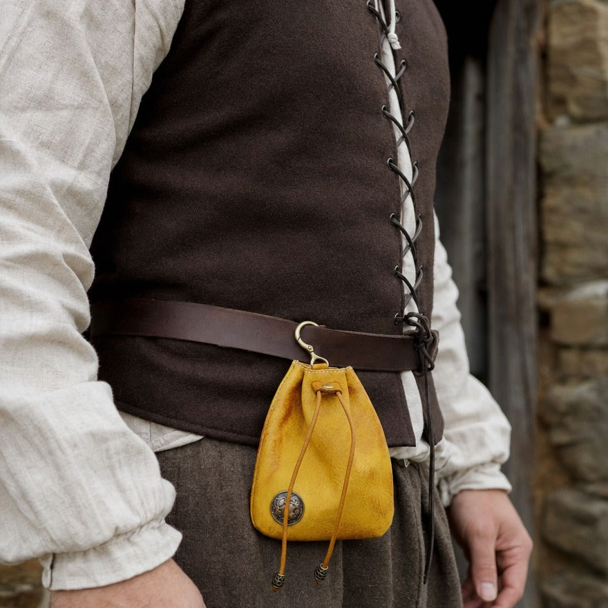 Leather drawstring coin pouch at a wearer's hip, showing its 11.5 × 9.5 cm size