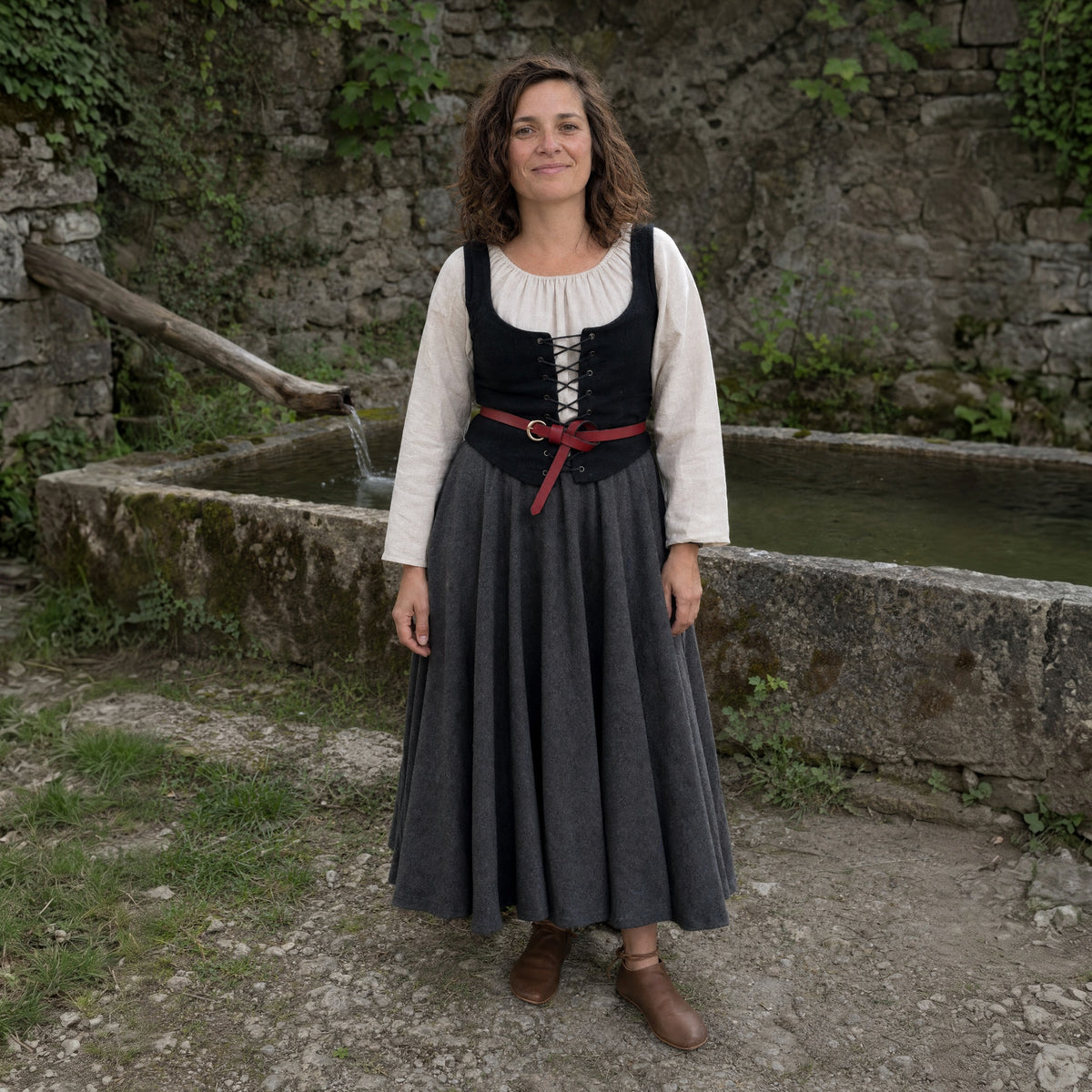 Red leather knot belt with ring worn by a woman outdoors, full-length front view