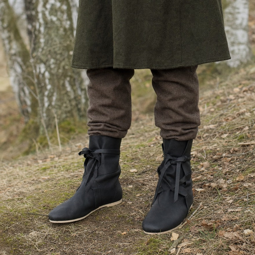 Low faux leather boots on a wearer, showing where the shaft sits on the ankle