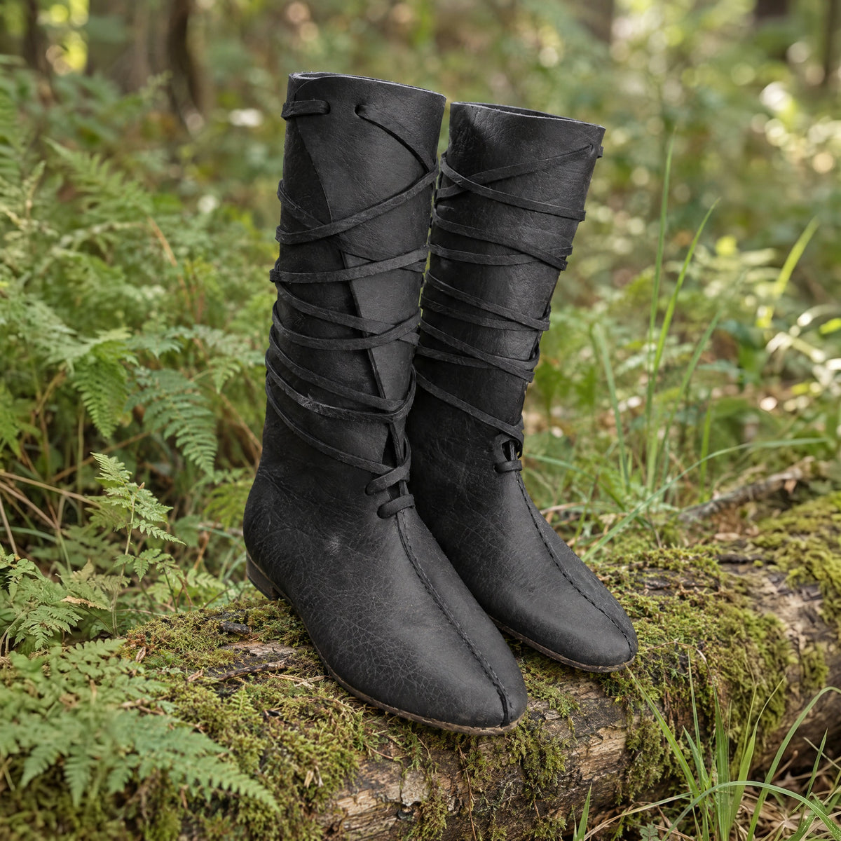 Black mid-calf lace-up boots on a rustic surface