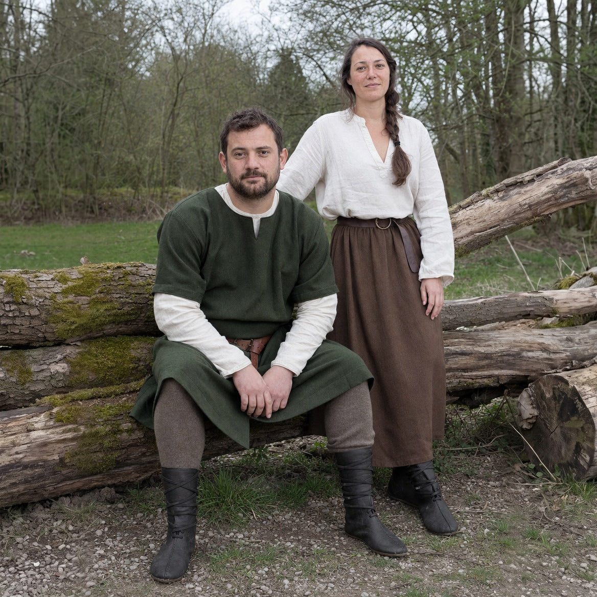 Mid-calf lace-up boots styled with trousers tucked in, a tunic and a belt