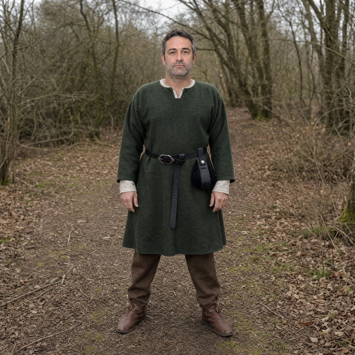 Black narrow belt with round pouch worn outdoors, full-length front view