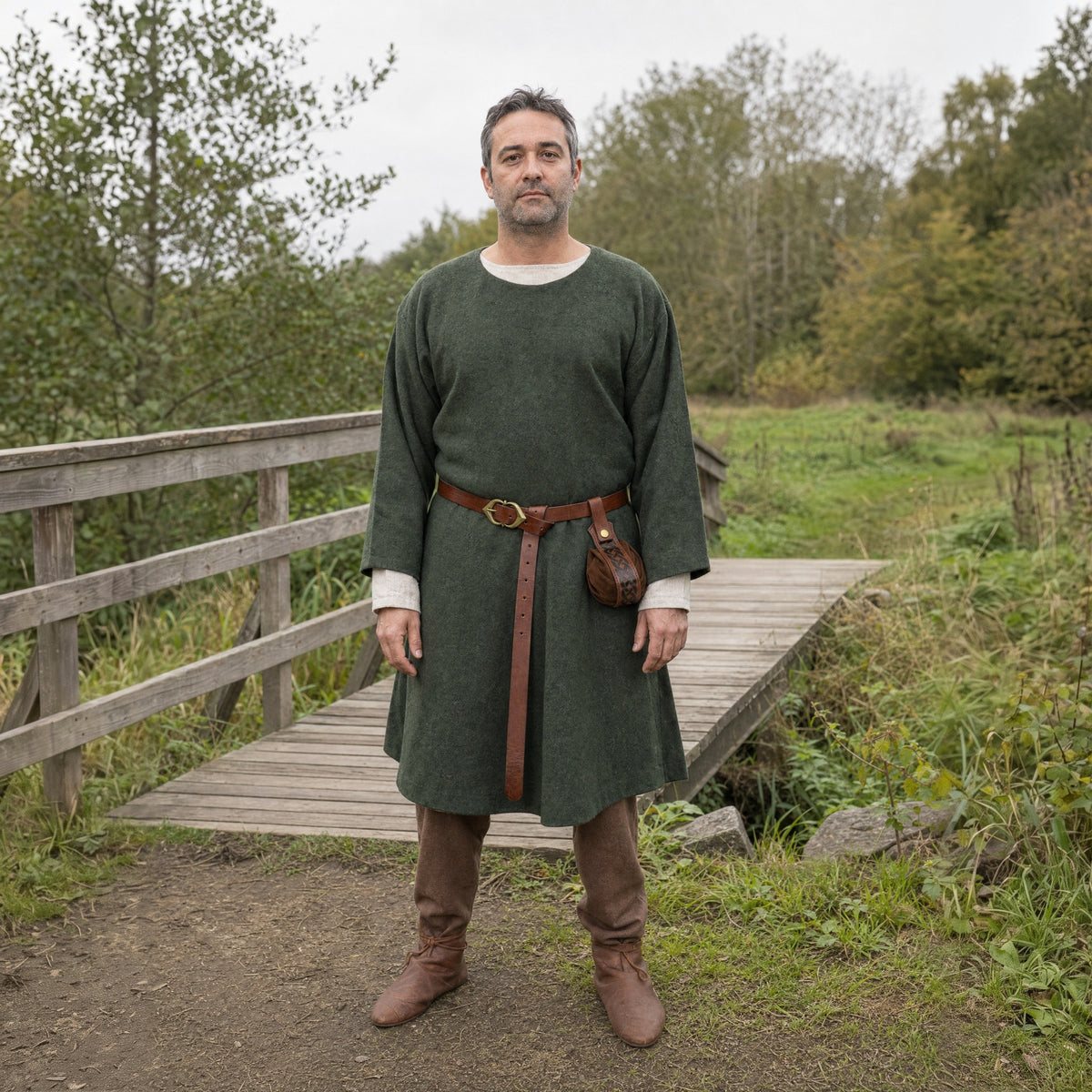 Brown narrow belt with round pouch worn outdoors, full-length front view