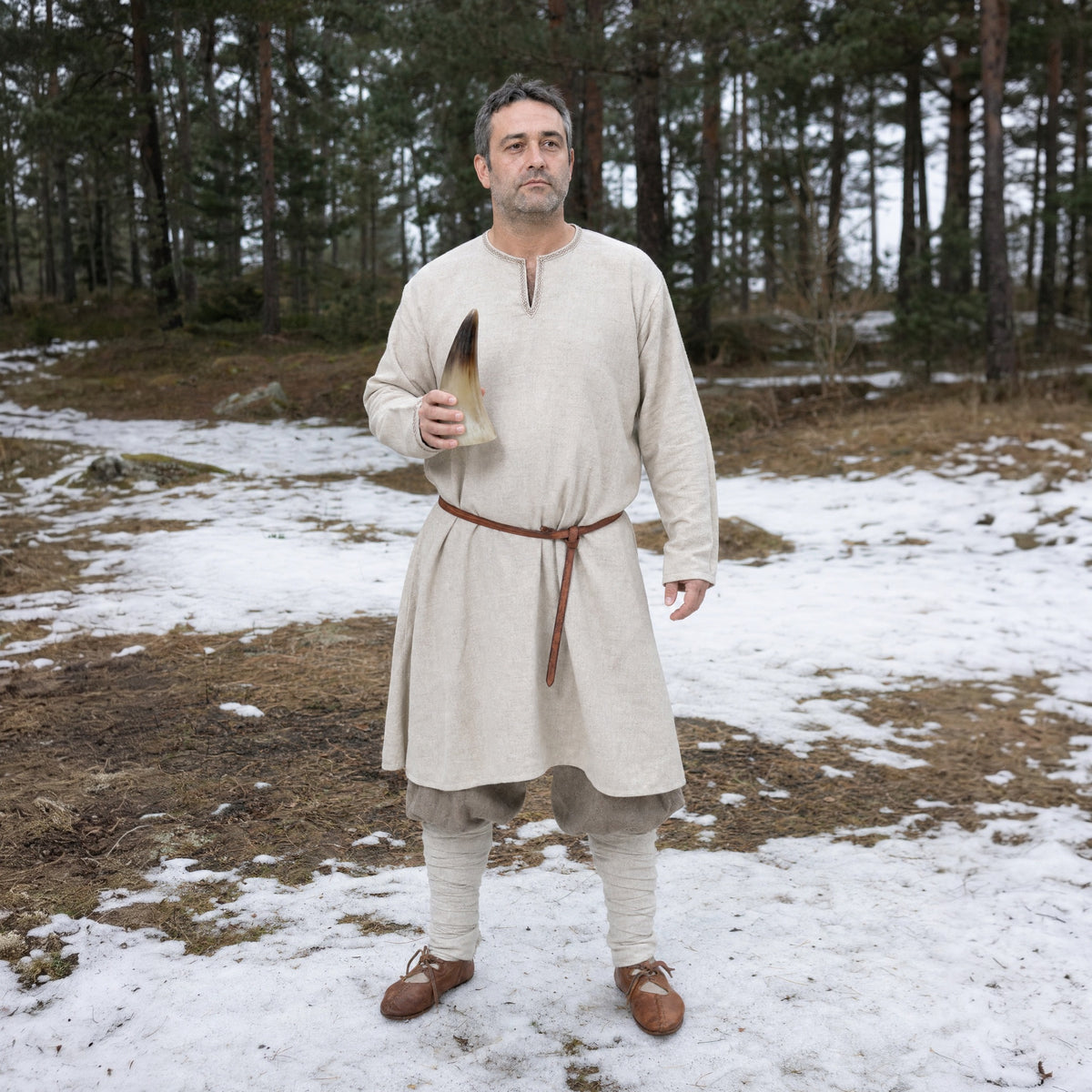Natural drinking horn worn outdoors, full-length front view
