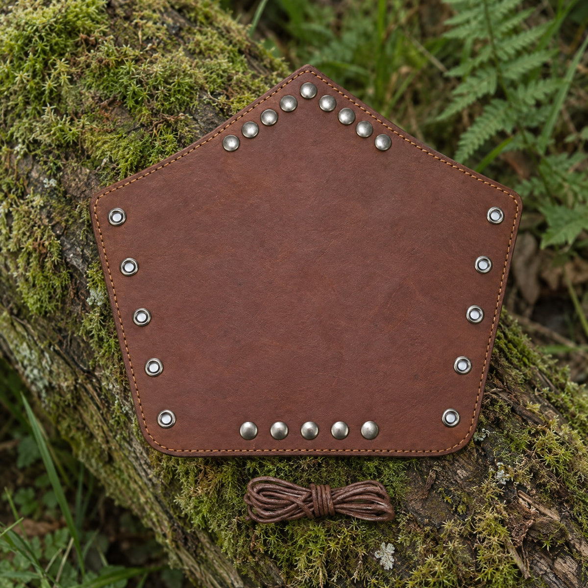 Camel plain studded bracer on a rustic surface