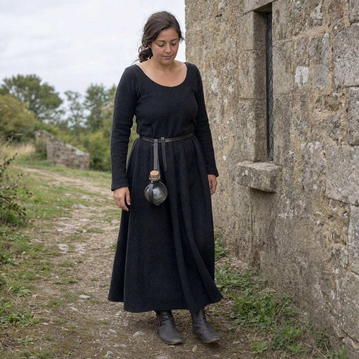 Black round potion bottle with belt holder worn outdoors