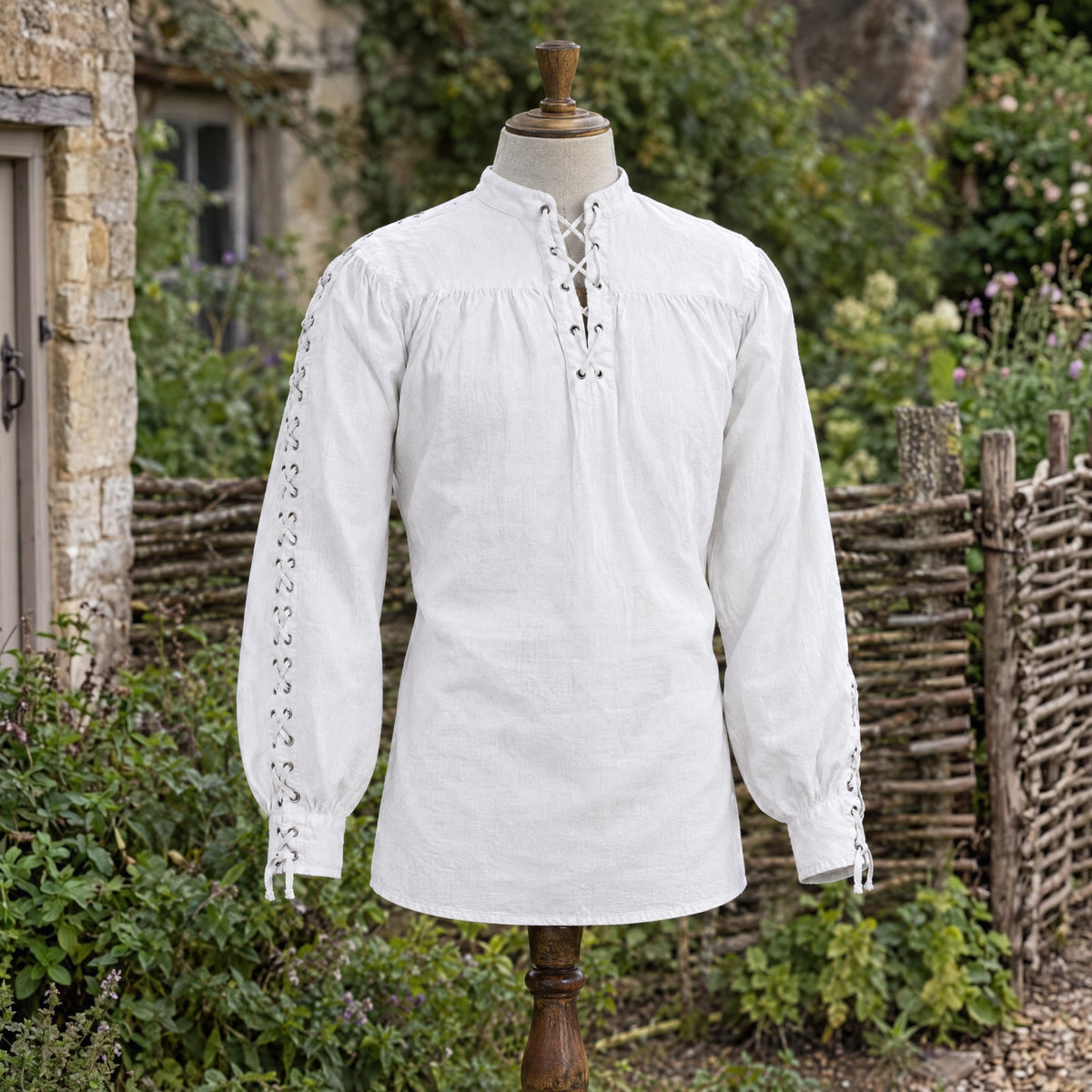 White renaissance shirt with laced sleeves on a dress form outdoors
