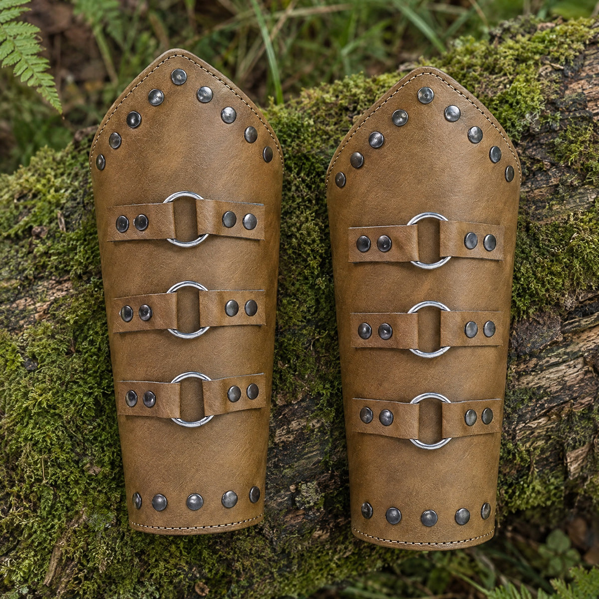 Camel riveted three-ring bracers on a rustic surface