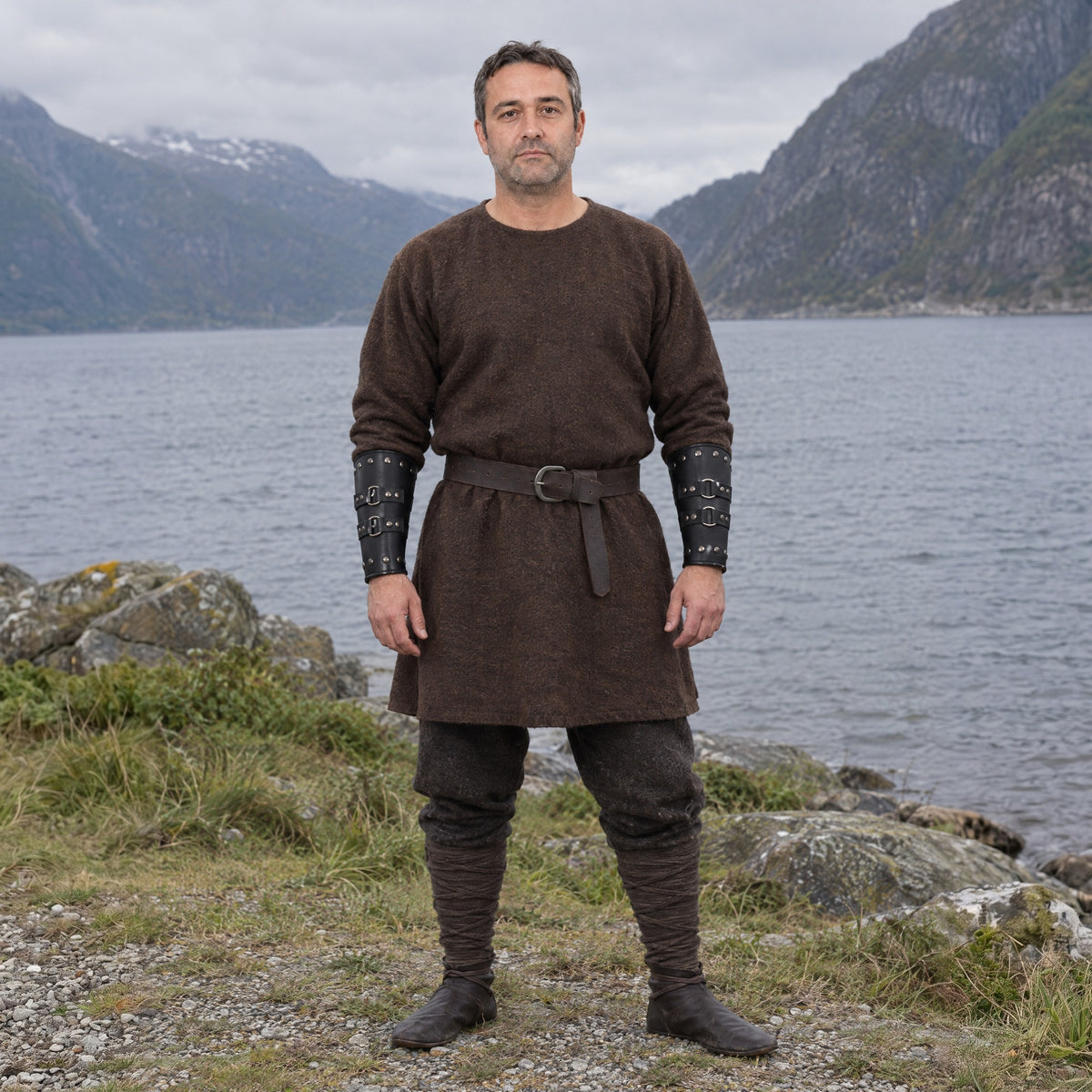 Black riveted three-ring bracers worn outdoors, full-length front view