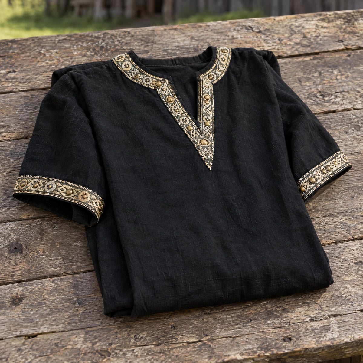 Black short-sleeve v-neck tunic on a rustic surface