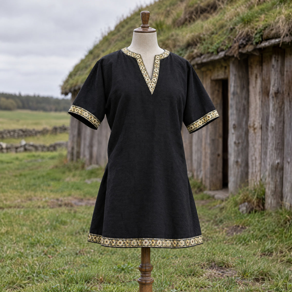 Black short-sleeve v-neck tunic on a dress form outdoors