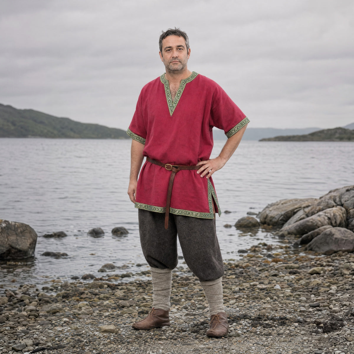 Red short-sleeve V-neck tunic worn by a man outdoors, full-length front view