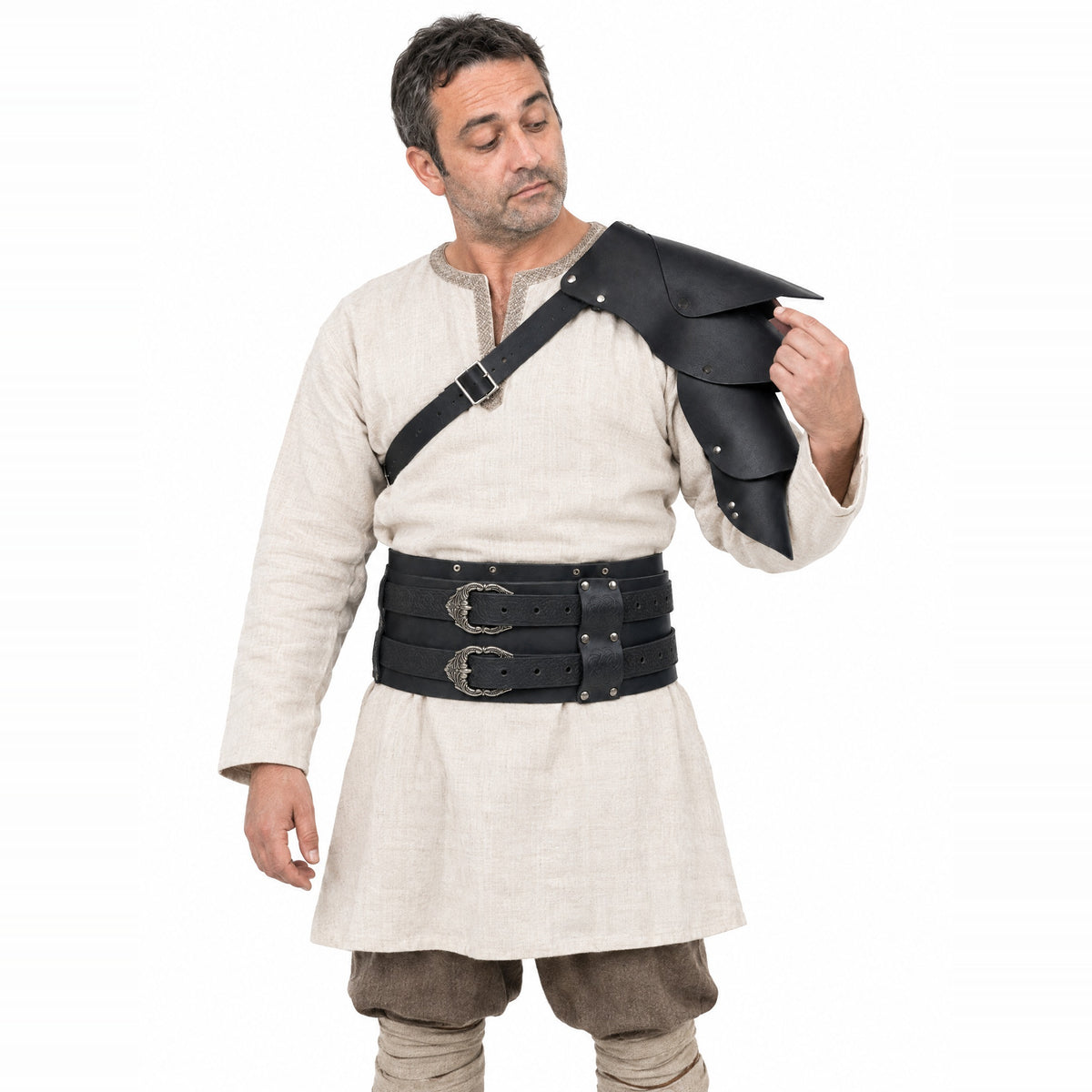 Black shoulder armour and wide belt set worn by a model on a white background