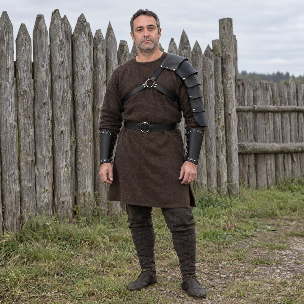 Black shoulder strap set with belt and bracers worn outdoors, full-length front view