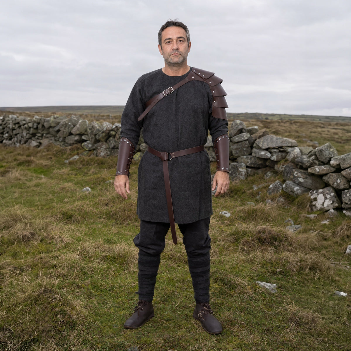 Brown shoulder strap set with belt and bracers worn outdoors, full-length front view