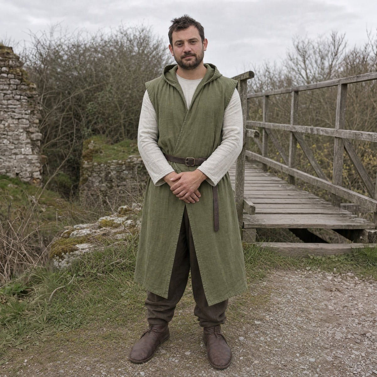 Army Green sleeveless cotton tunic worn by a man outdoors, full-length front view