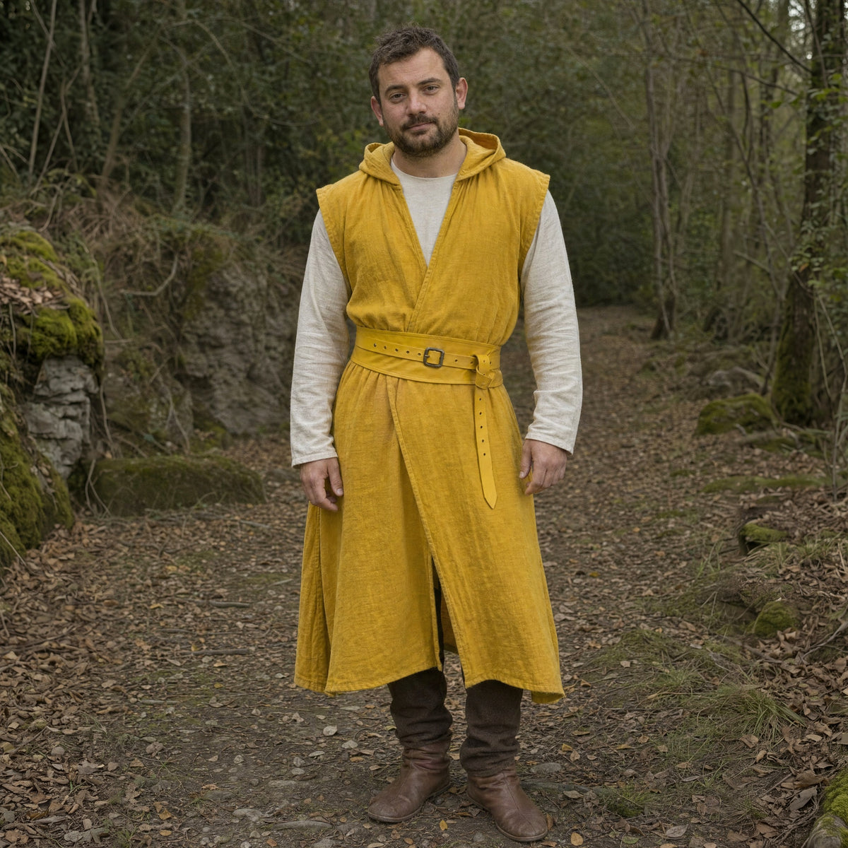 Yellow sleeveless cotton tunic worn by a man outdoors, full-length front view