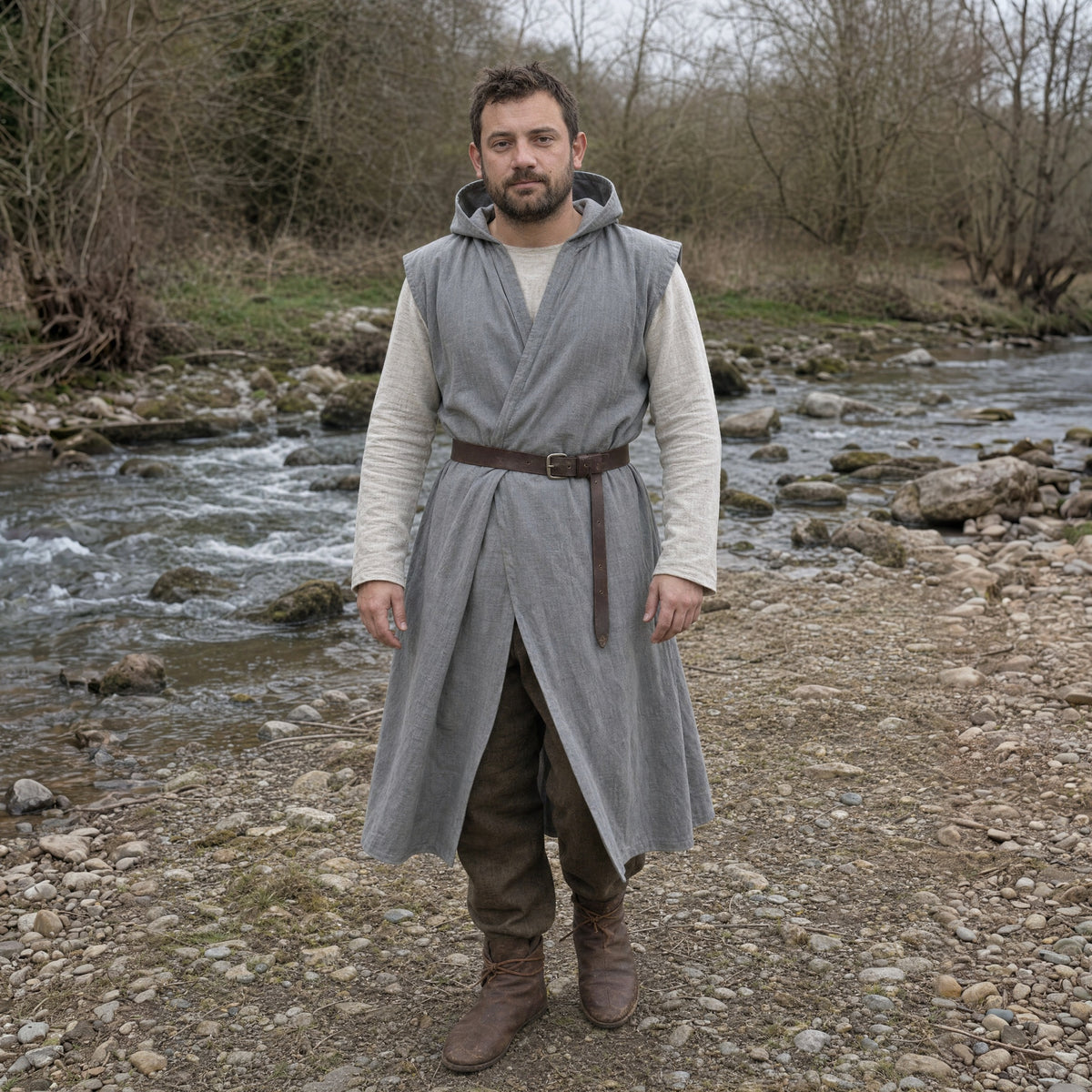 Grey sleeveless cotton tunic worn by a man outdoors, full-length front view