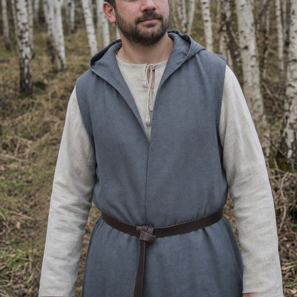 Sleeveless hooded overcoat on a wearer, showing the 124–128 cm length below the knee