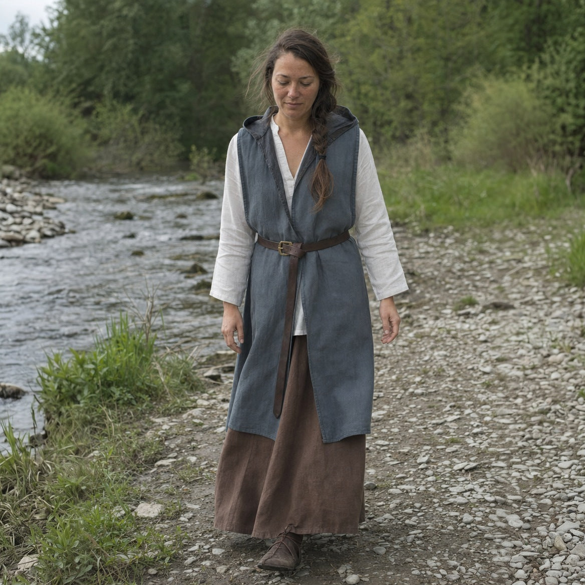 Grey sleeveless hooded overcoat worn outdoors