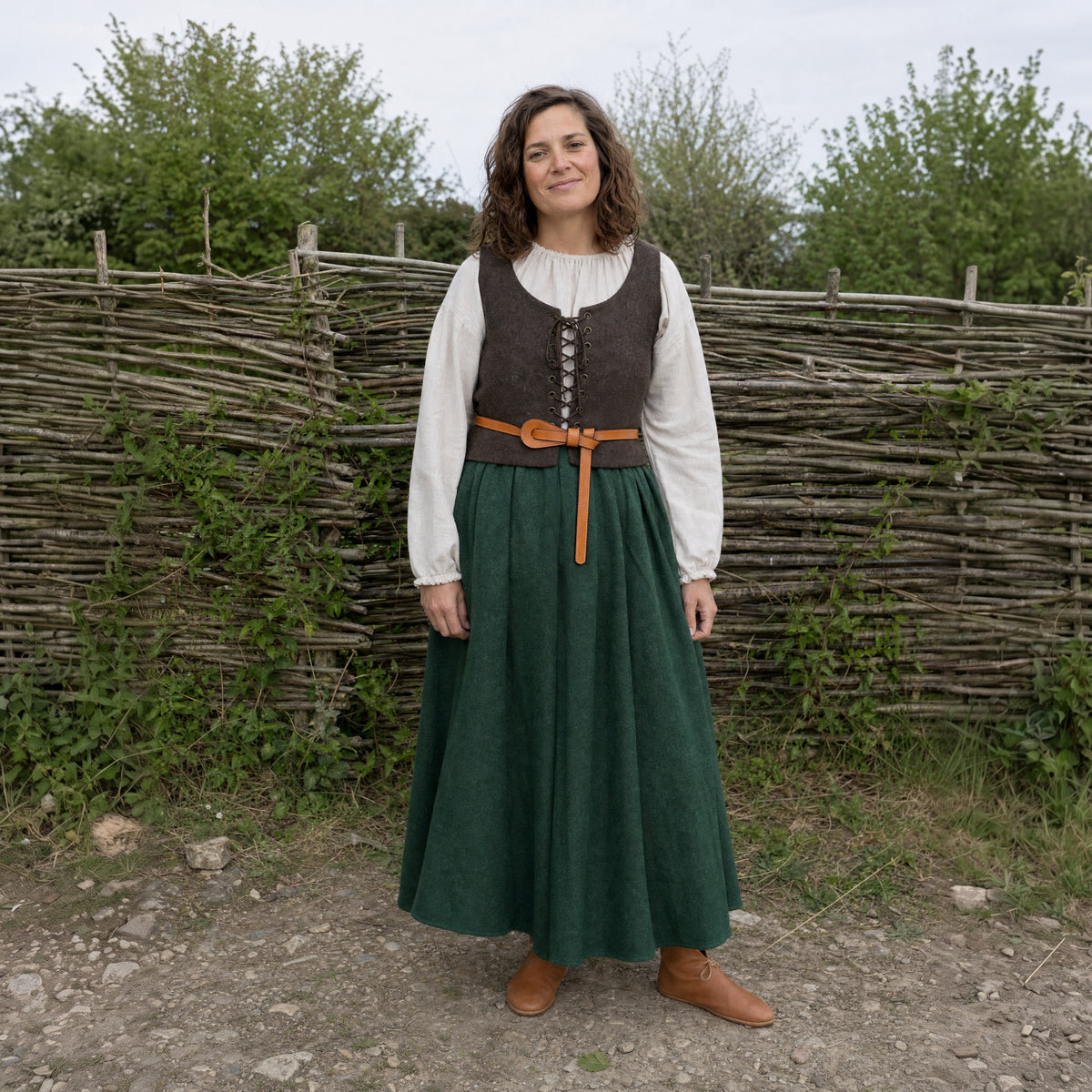Camel slim leather tie belt knotted at a woman's waist outdoors, full-length front view