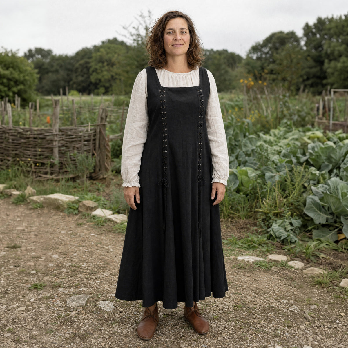 Black square-neck lace-up Renaissance dress worn by a woman outdoors, full-length front view
