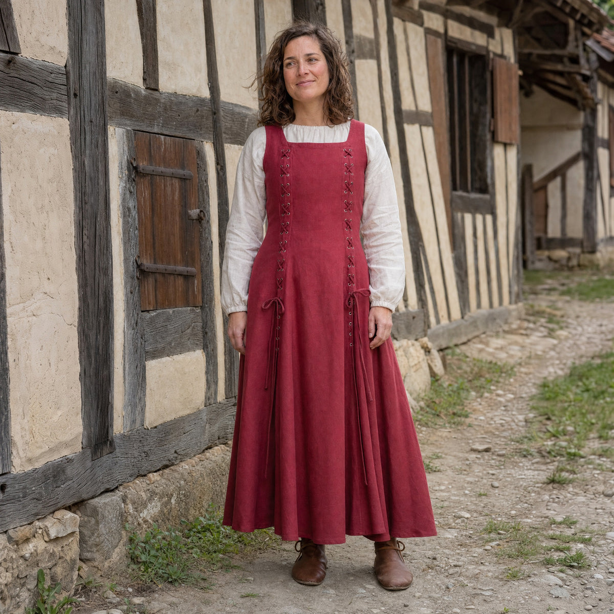 Red square-neck lace-up Renaissance dress worn by a woman outdoors, full-length front view