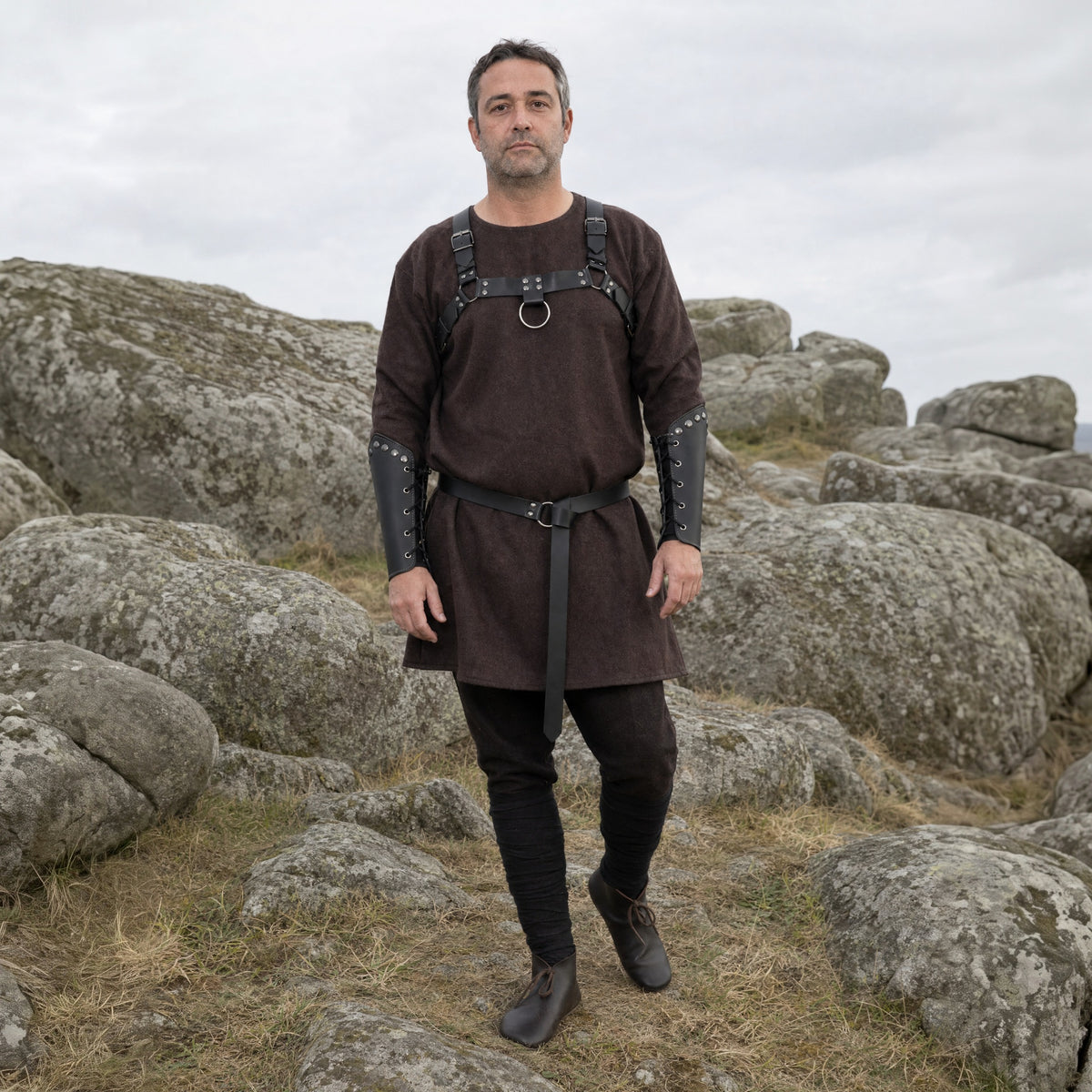 Black chest strap set with belt and bracers worn outdoors, full-length front view