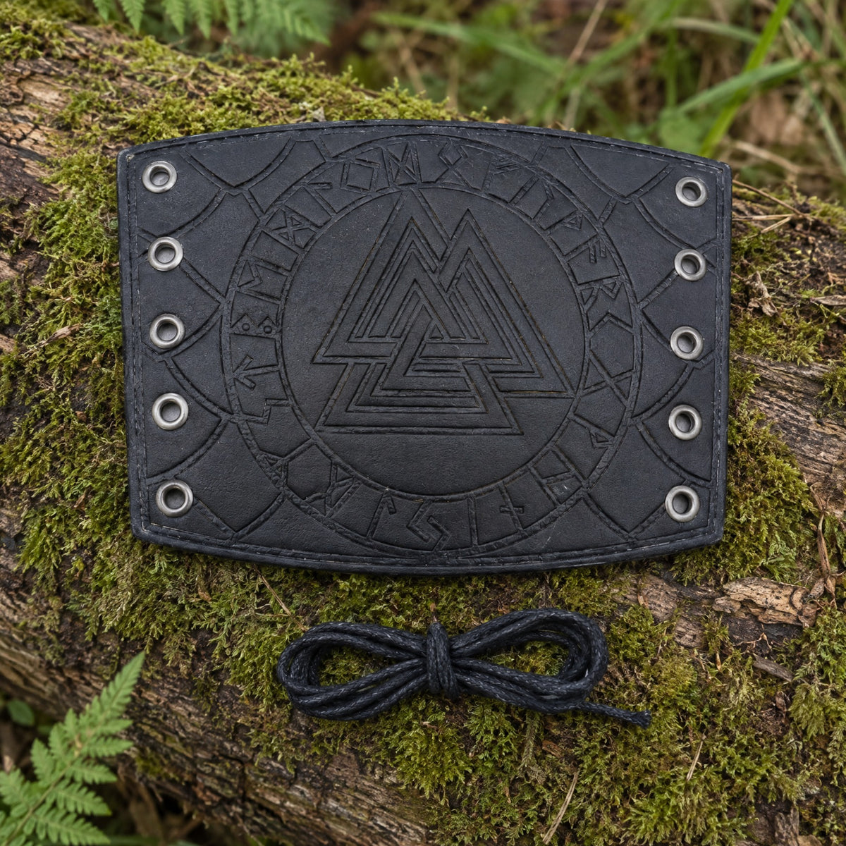 Black Valknut bracer on a rustic surface