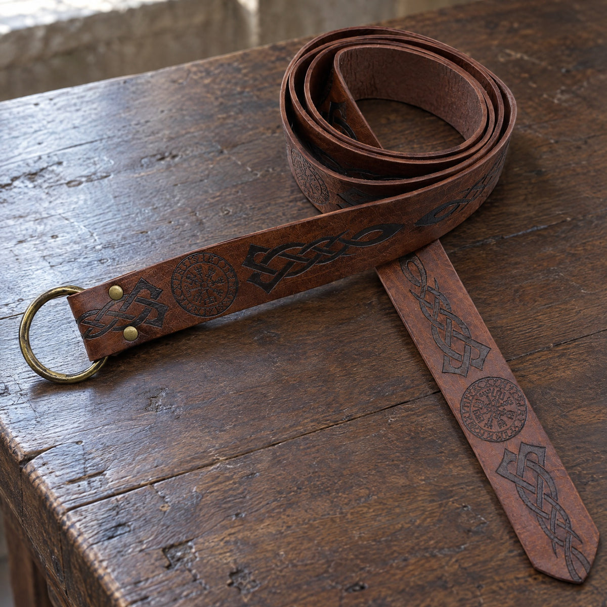 Brown Vegvisir knotwork ring belt on a rustic surface