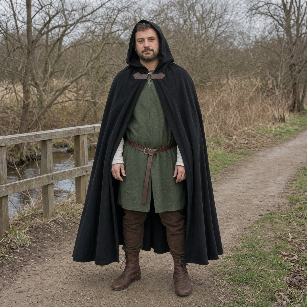 Black velvet hooded cloak worn outdoors, full-length front view