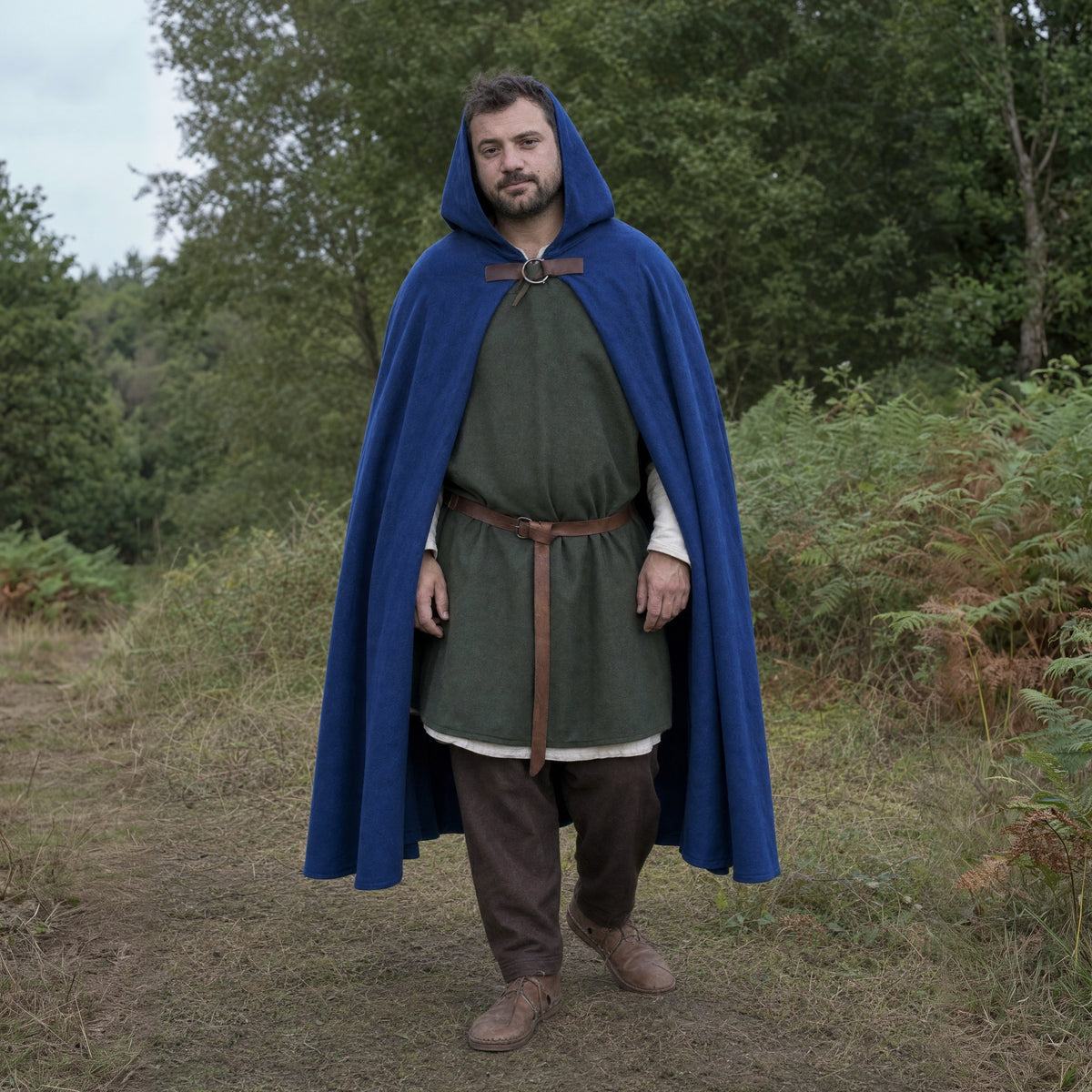 Blue velvet hooded cloak worn outdoors, full-length front view