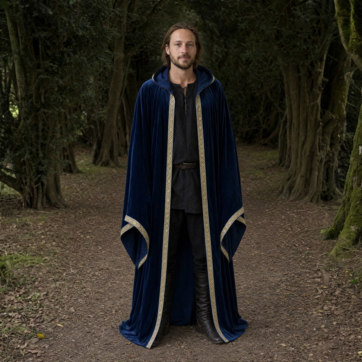 Blue velvet hooded robe with printed trim worn outdoors, full-length front view