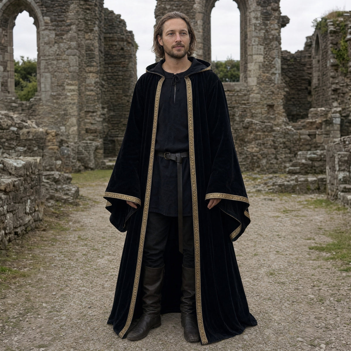 Black velvet hooded robe with printed trim worn outdoors, full-length front view