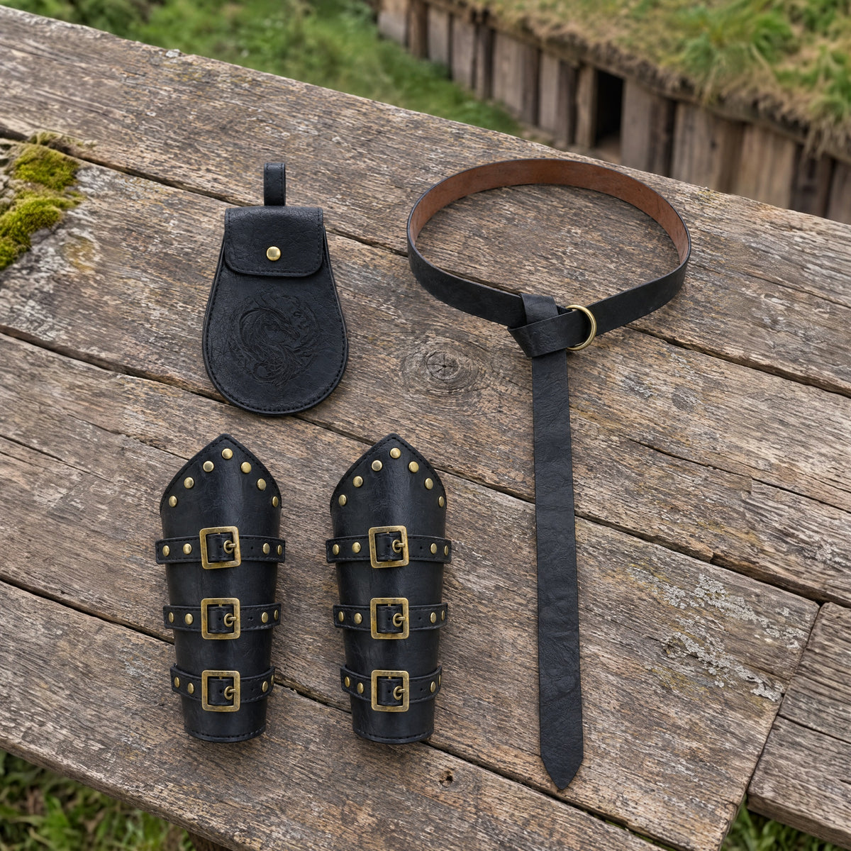 Black Viking belt, pouch and bracers set on a rustic surface