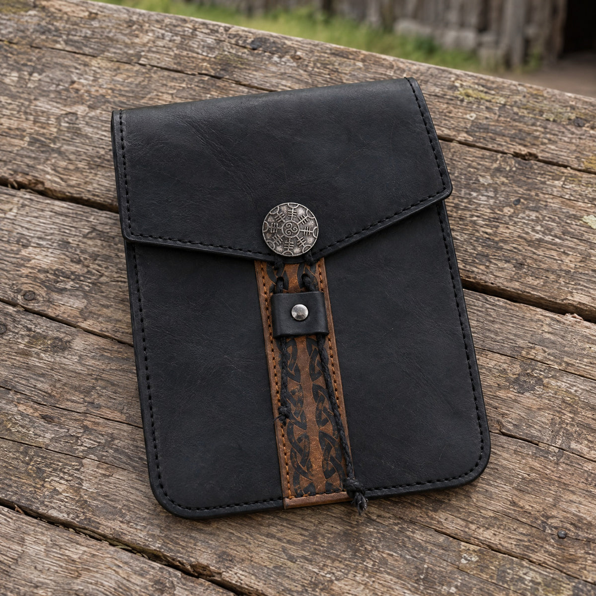 Black tall Viking belt pouch on a rustic surface