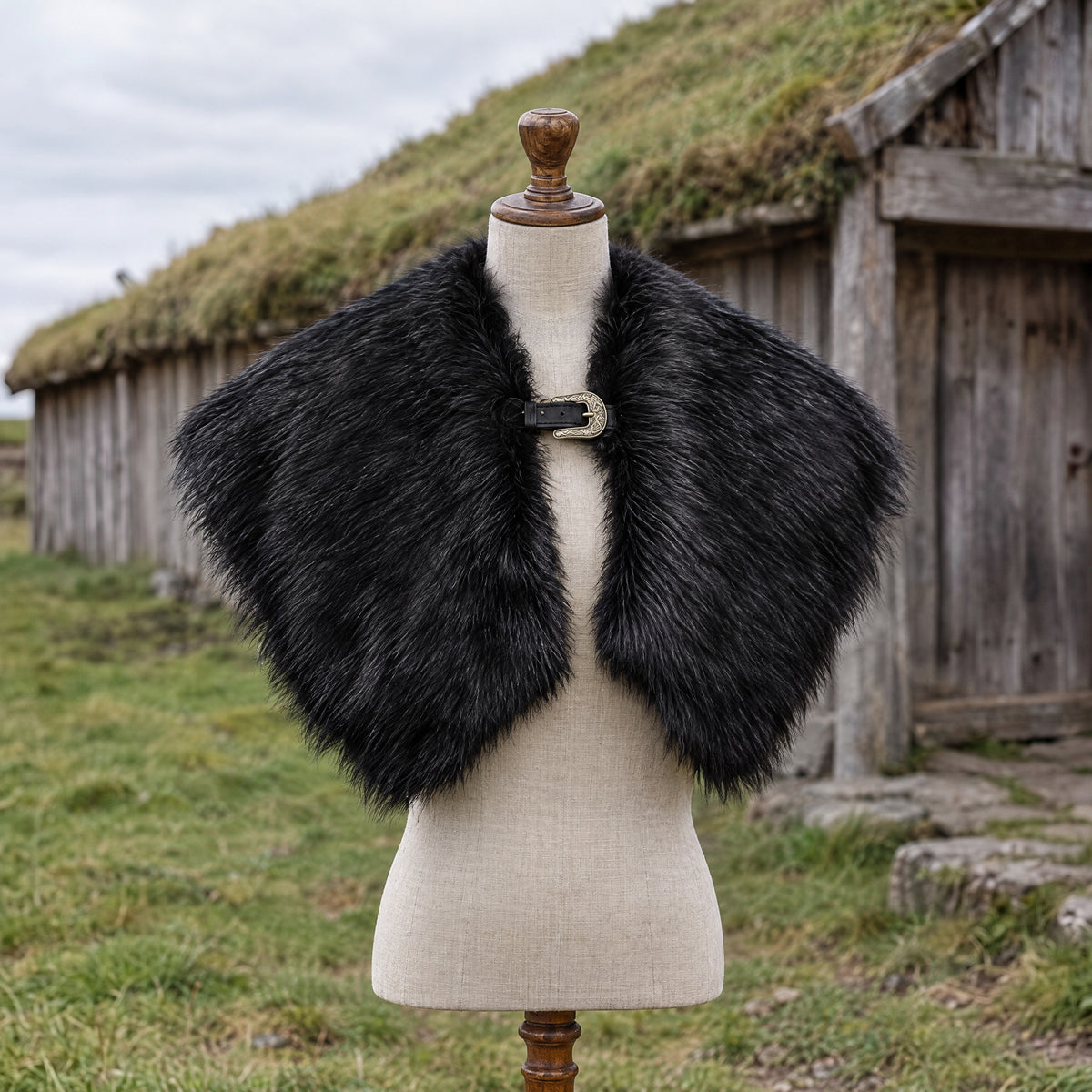 Black viking faux fur shoulder cape on a dress form outdoors