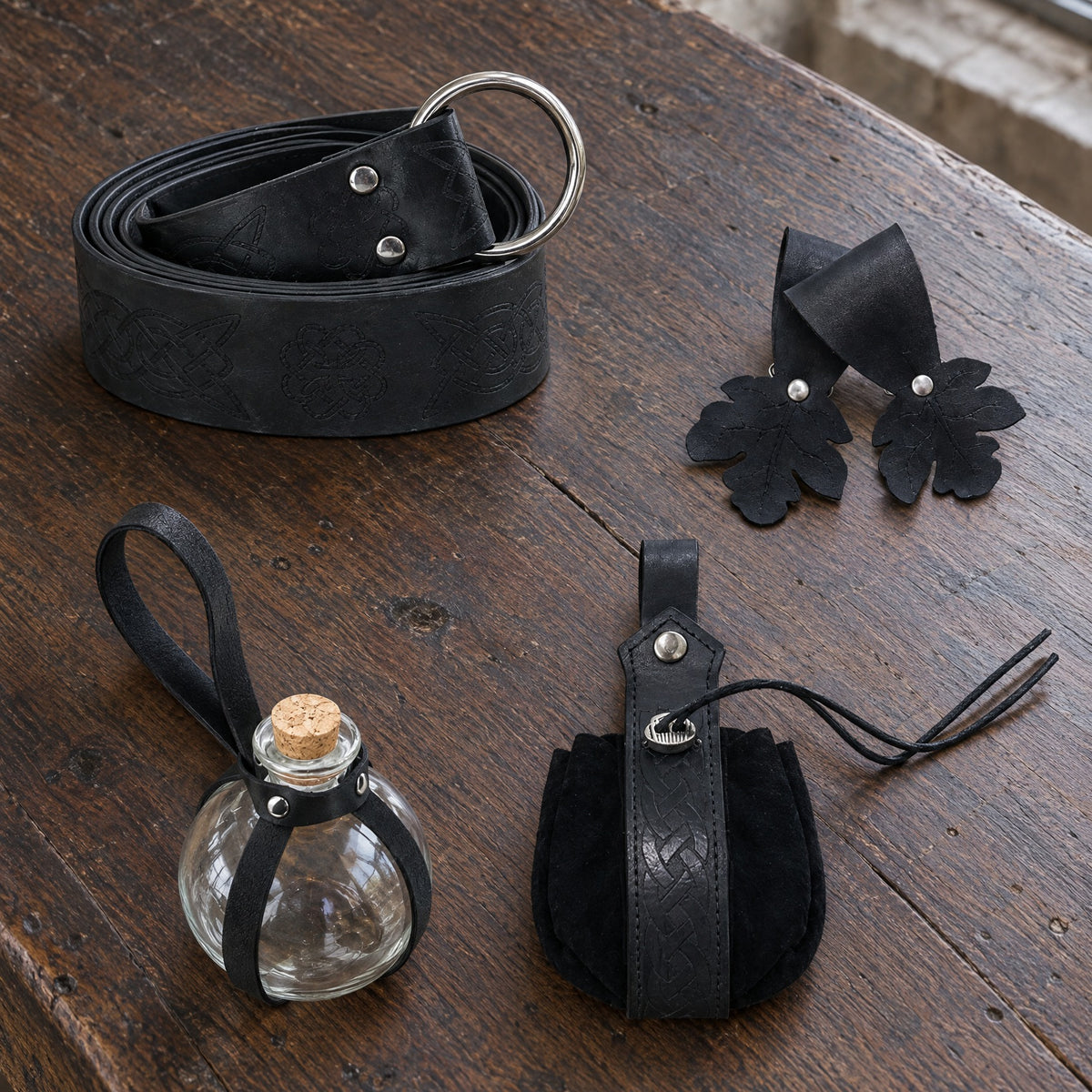 Black wide ring belt kit with oak leaf hanger on a rustic surface
