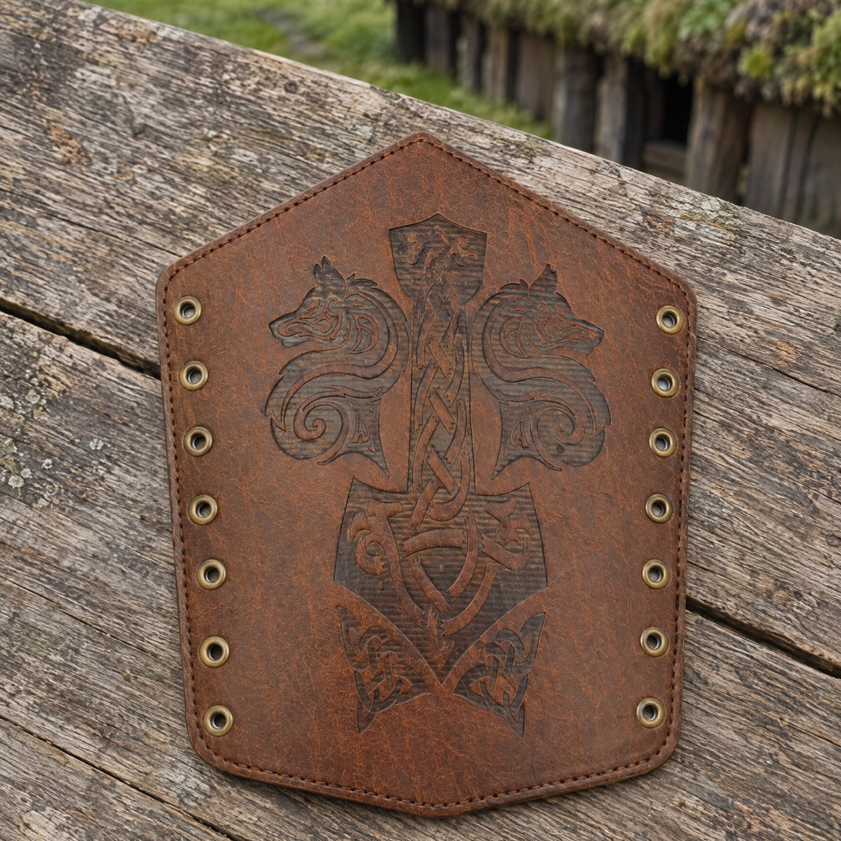 Light brown wolf and hammer bracer on a rustic surface